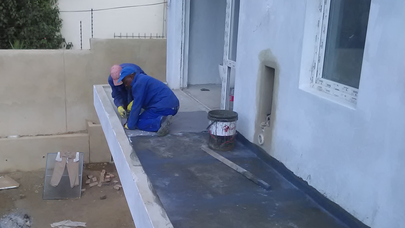 Cementitious waterproofing being applied to a balcony in Kempton Park